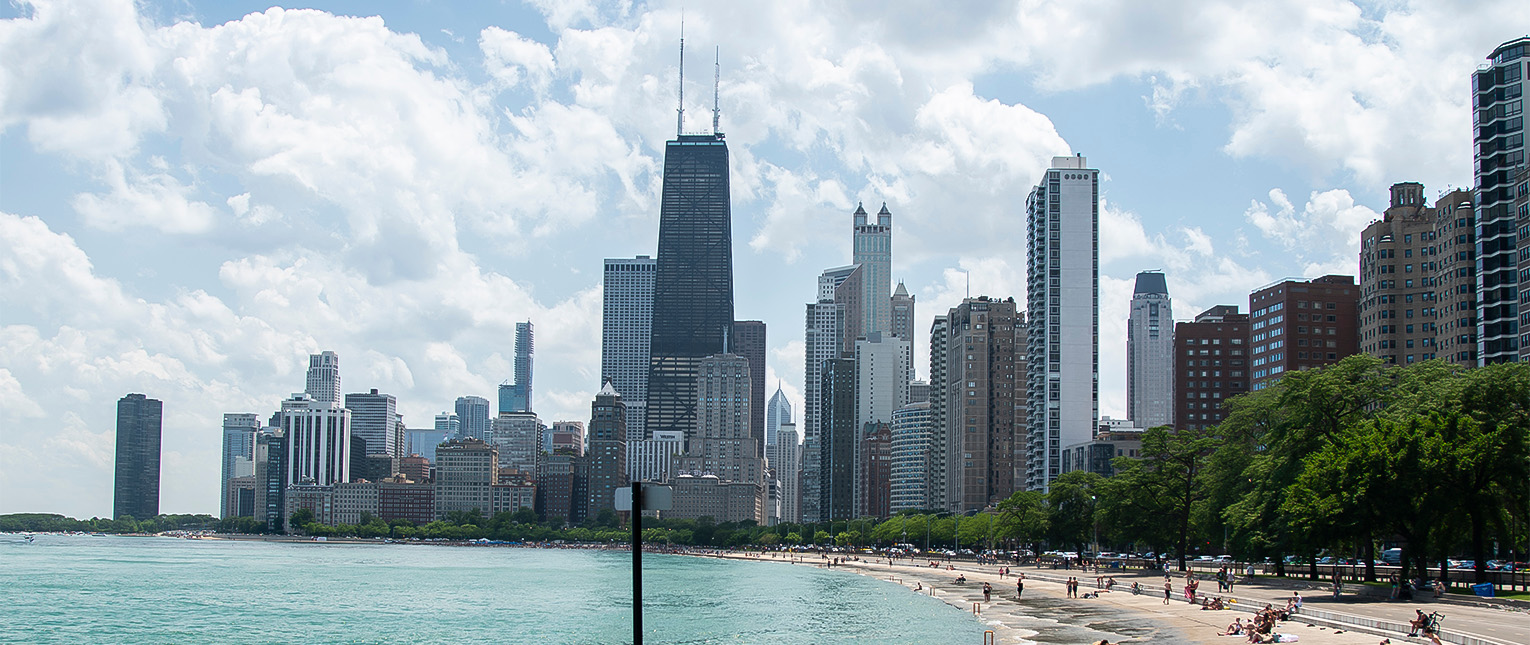 a city skyline with a beach and water