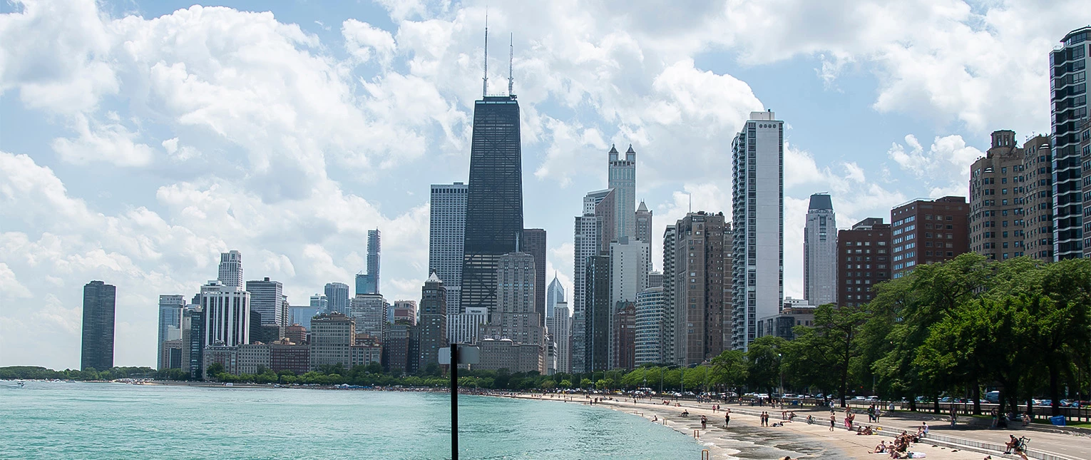 a city skyline with a beach and water