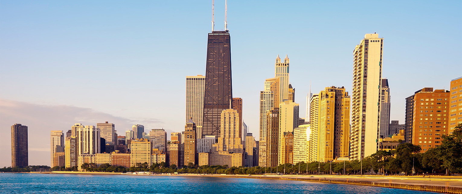 a city skyline with a body of water