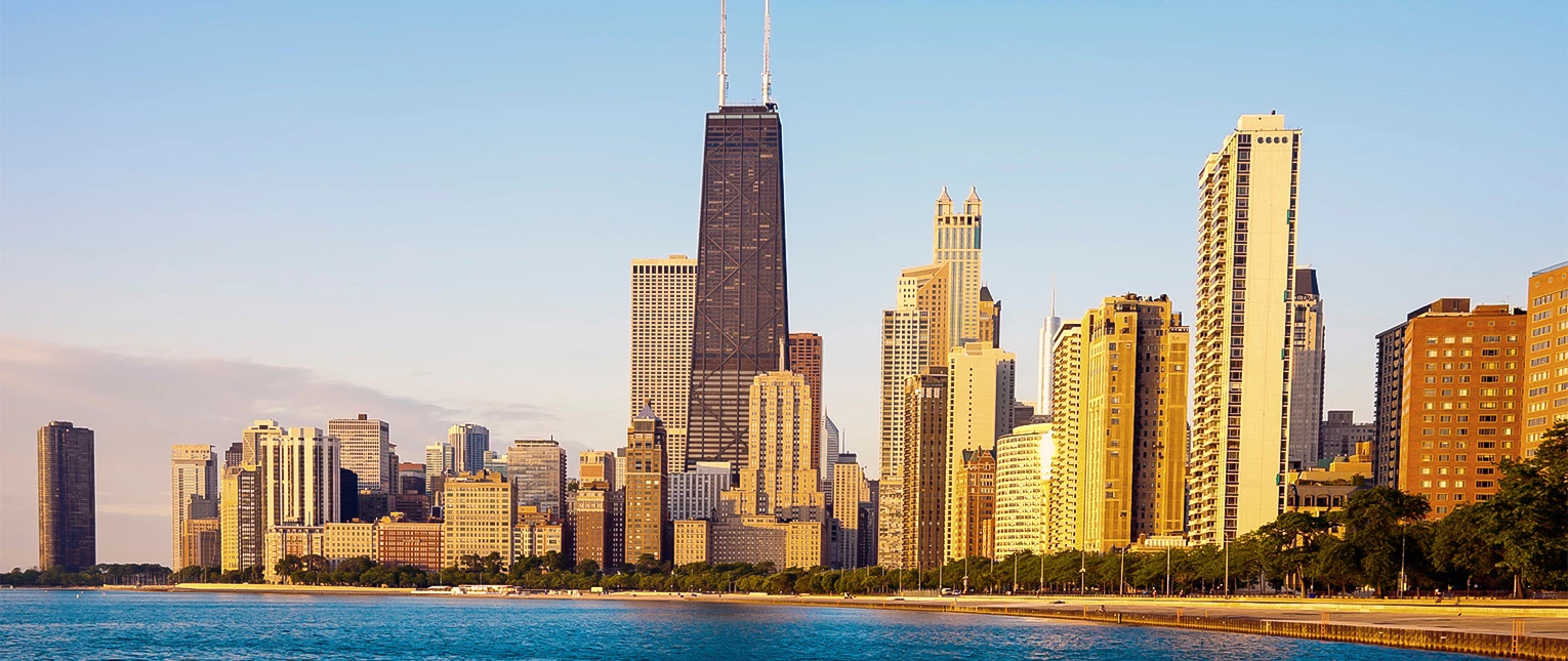 a city skyline with a body of water