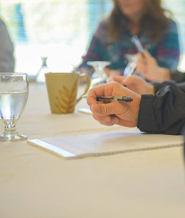 a person writing on a piece of paper