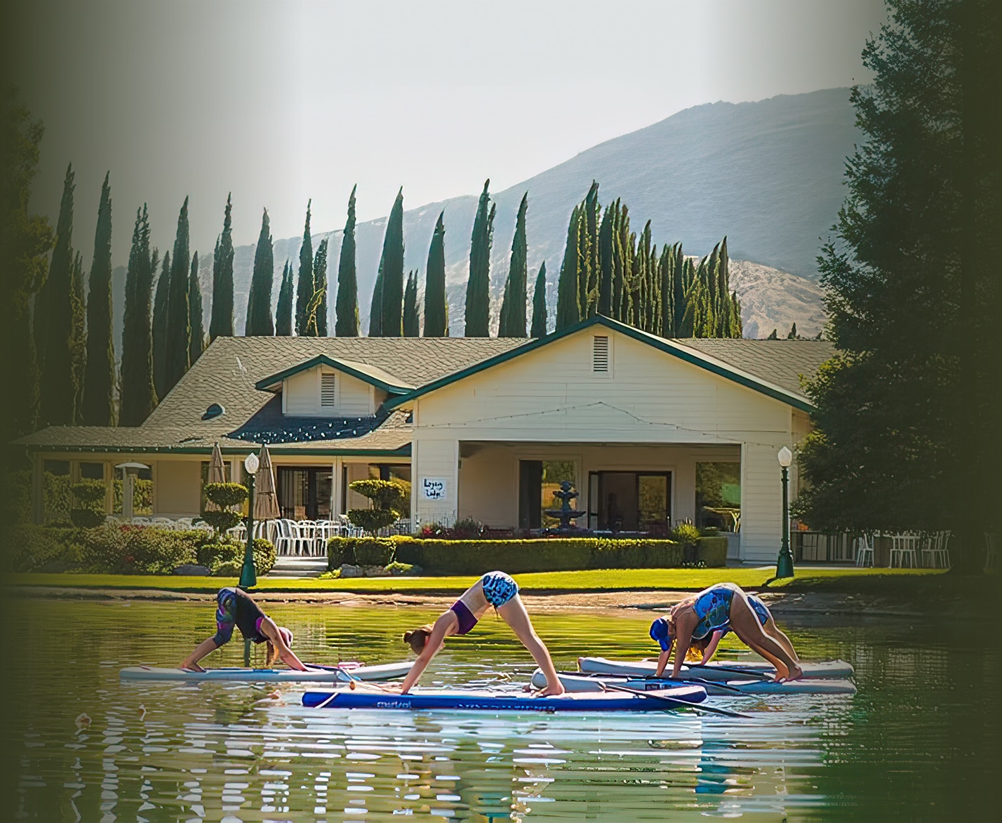 a group of people on surfboards in a lake