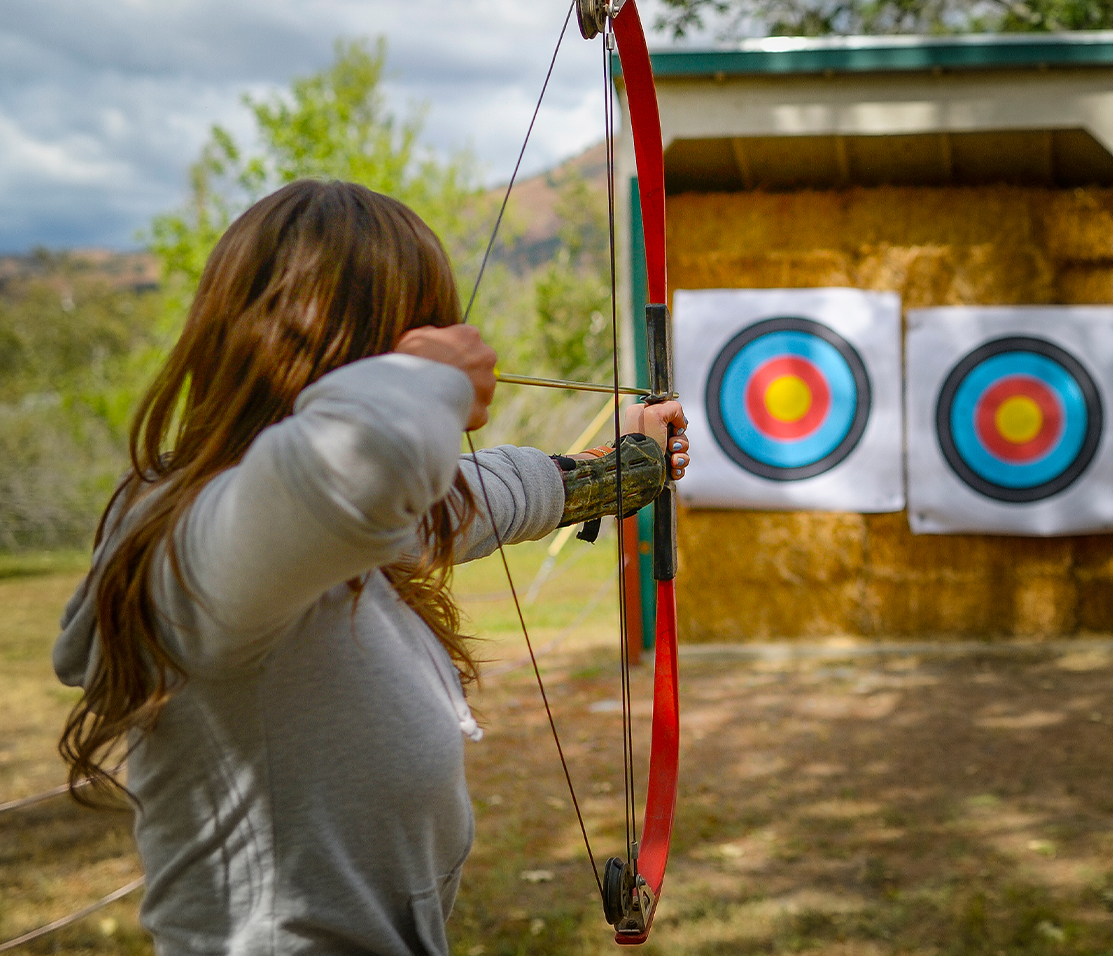a girl holding a bow and arrow