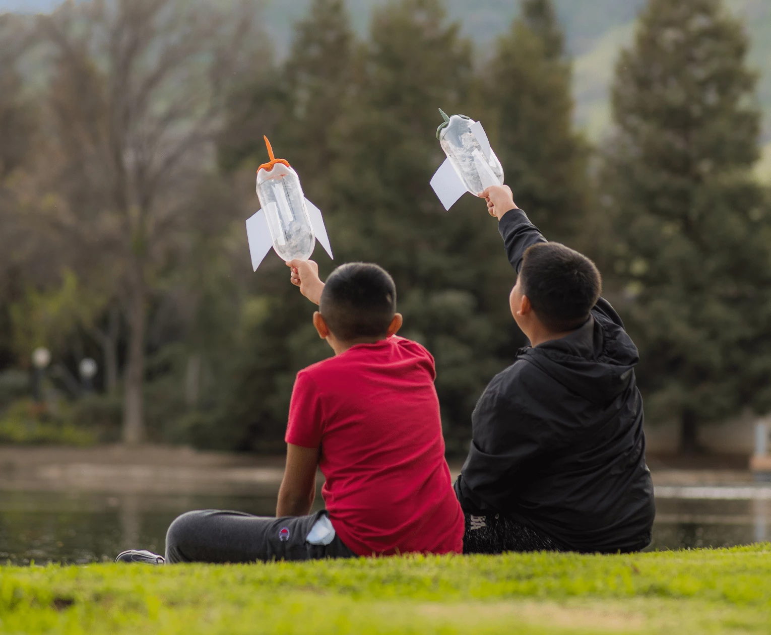 a group of boys sitting on grass