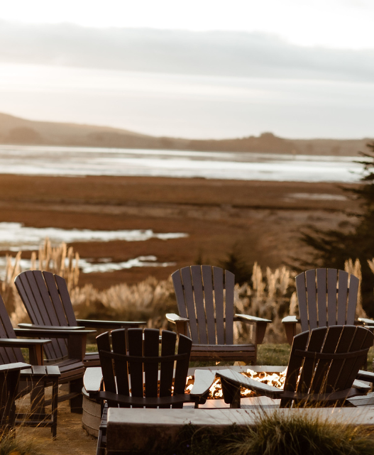 a group of chairs around a fire pit