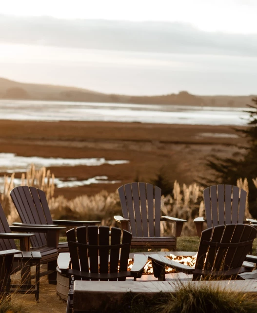 a group of chairs around a fire pit