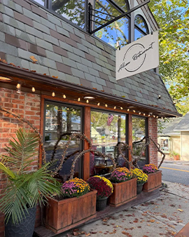 a restaurant with flowers in pots