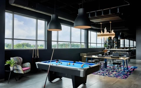 a pool table near the big windows