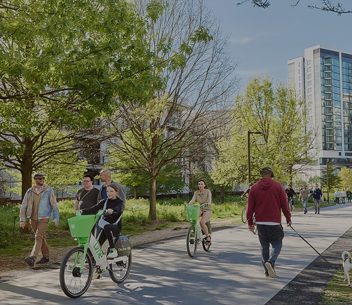 a group of people riding bicycles on a sidewalk