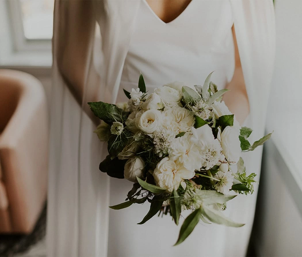 Woman holding a bouquet of white flowers at The Wylie Hotel in Midtown Atlanta 
