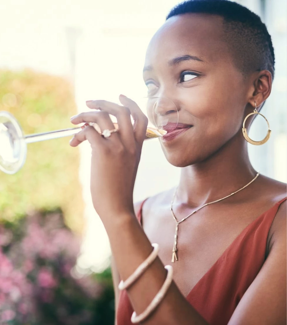 a woman drinking from a glass