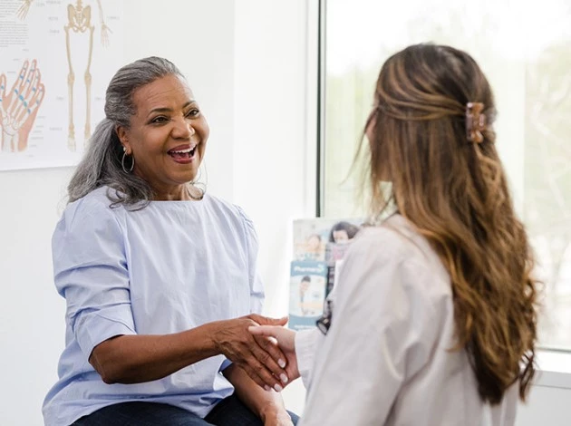 a woman talking to another woman doctor