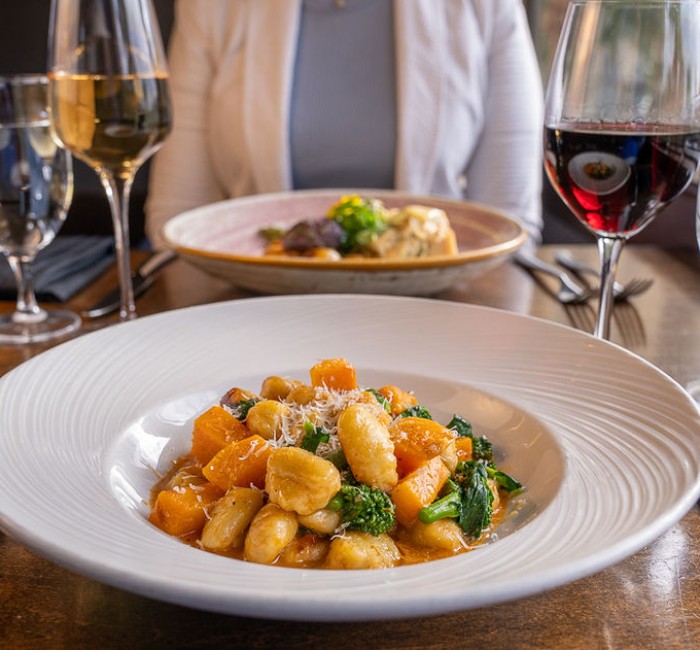 a plate of food and wine glasses on a table