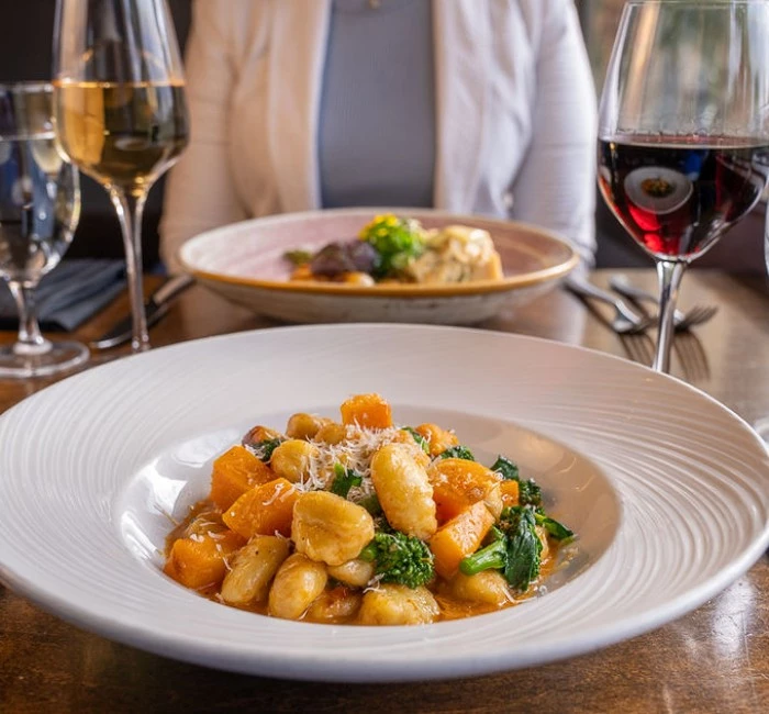 a plate of food and wine glasses on a table