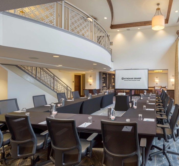 a large conference room with a screen and chairs