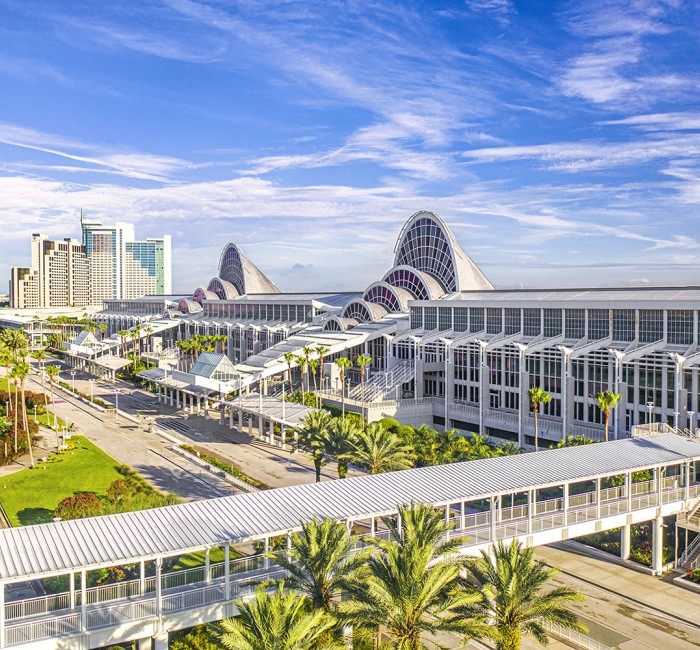a large white building with many windows and a walkway