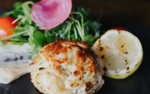 a plate of food with lemons and radishes