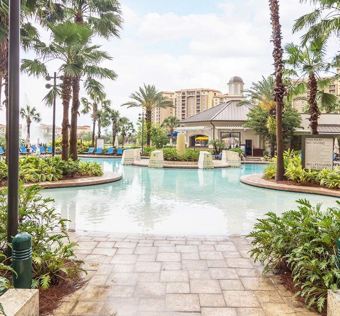 a view of the pool at the hotel on a sunny clear sky day