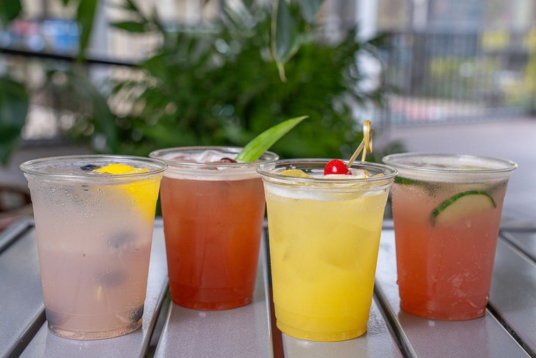 a group of drinks in plastic cups