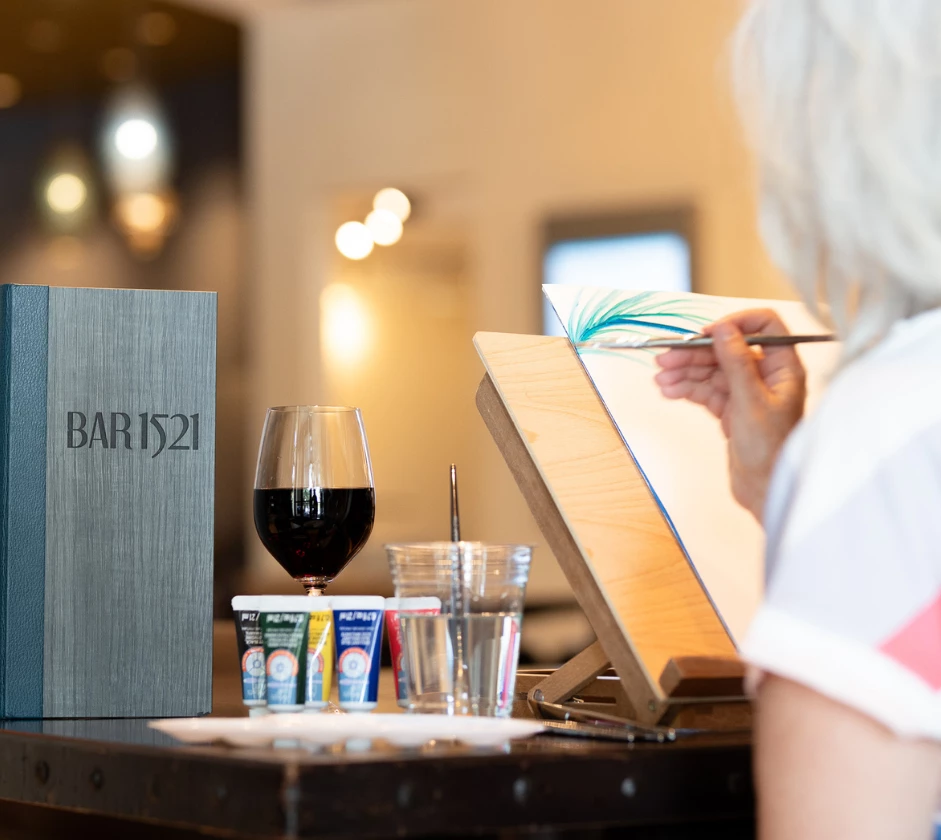 a woman painting a picture on a table