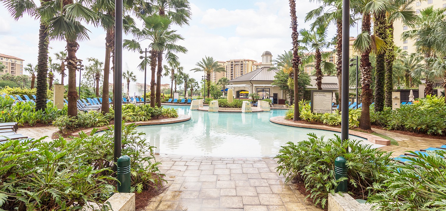 a view of the pool at the hotel on a sunny clear sky day