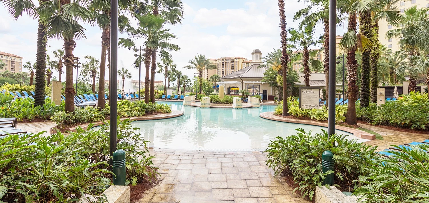 a view of the pool at the hotel on a sunny clear sky day