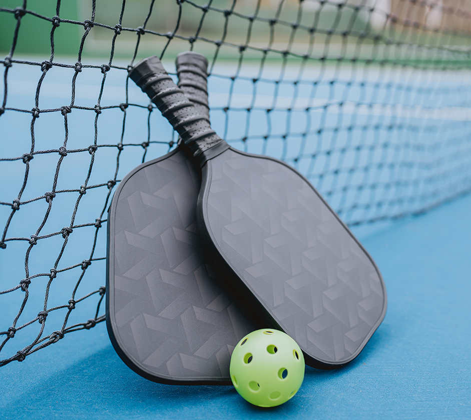 paddles and a ball next to a net
