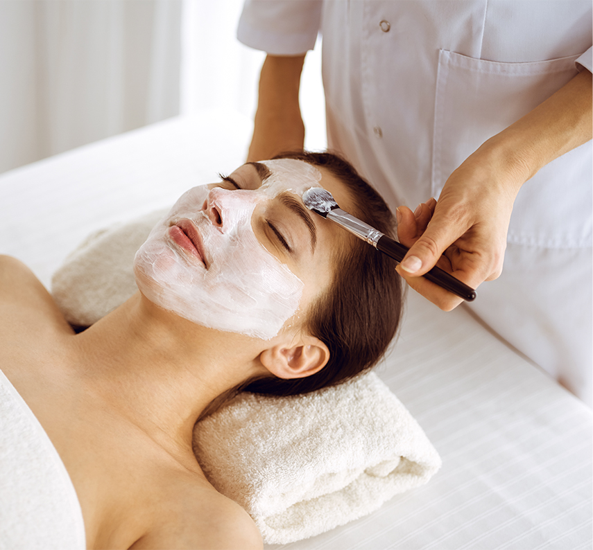 a woman receiving a facial mask