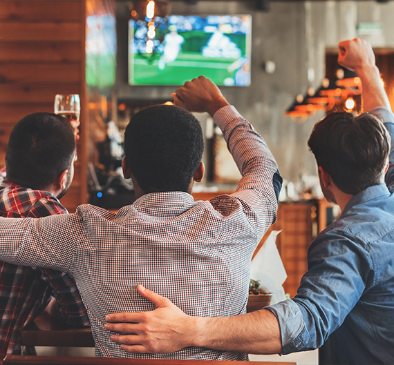 a group of men watching a football game