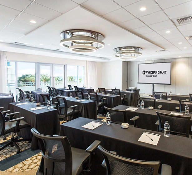 black long tables with large screen projection screens