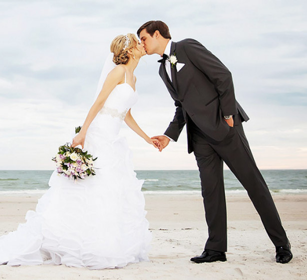 woman kissing a man on the beach