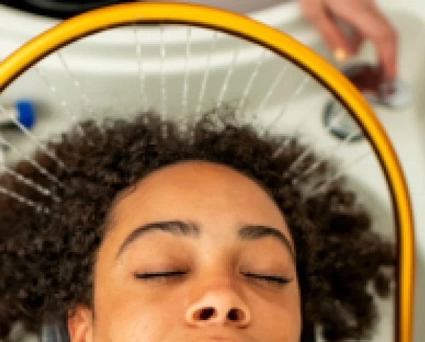 a woman with her eyes closed under a yellow hoop