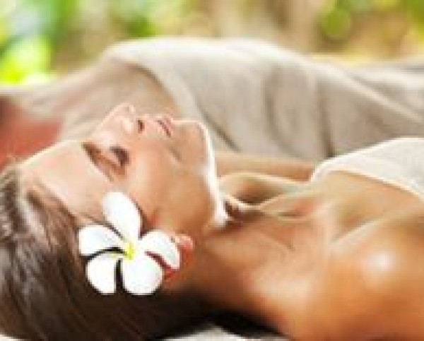 a woman lying down with a flower in her hair