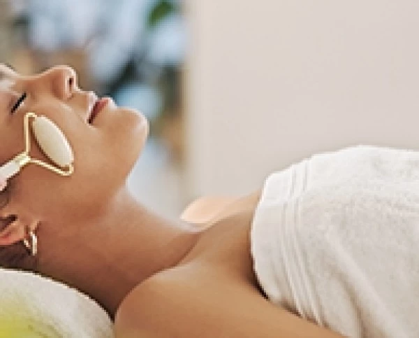 a woman lying down with a massage tool