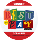 a round red and white sticker with colorful text