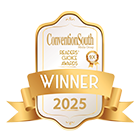 a white and gold label with a gold ribbon