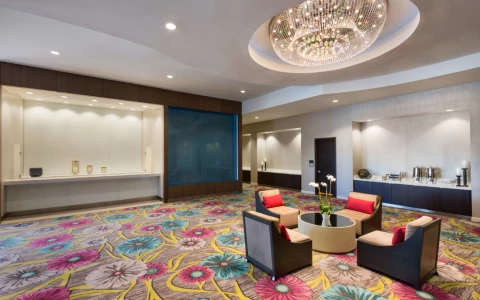 a room with colorful carpet and chairs