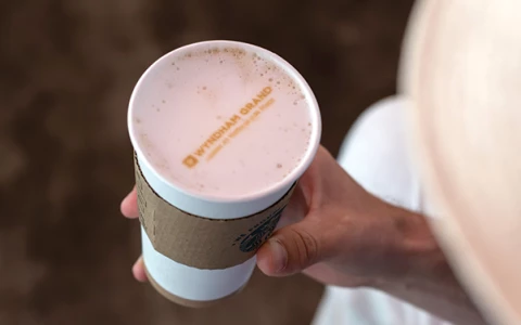 a person holding a cup of coffee