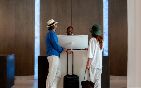 a group of people standing at a reception desk