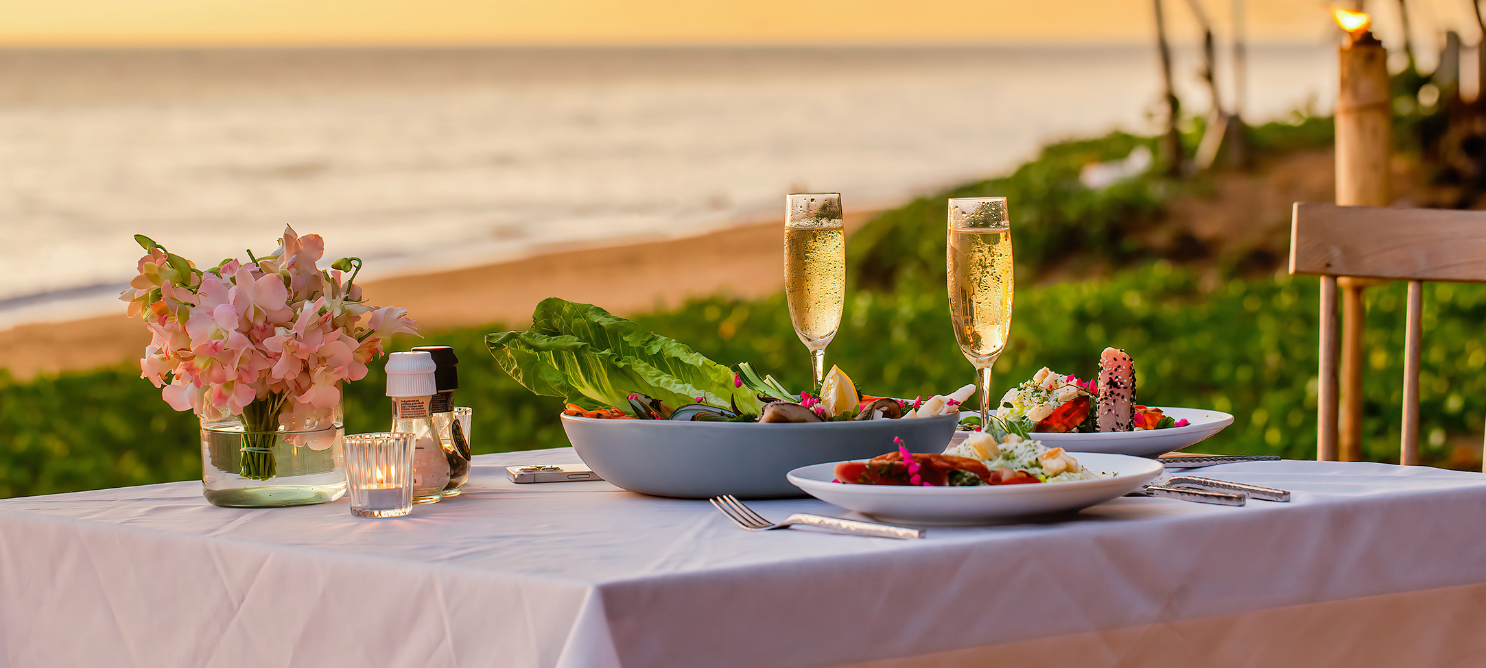 a table with plates of food and champagne glasses on it