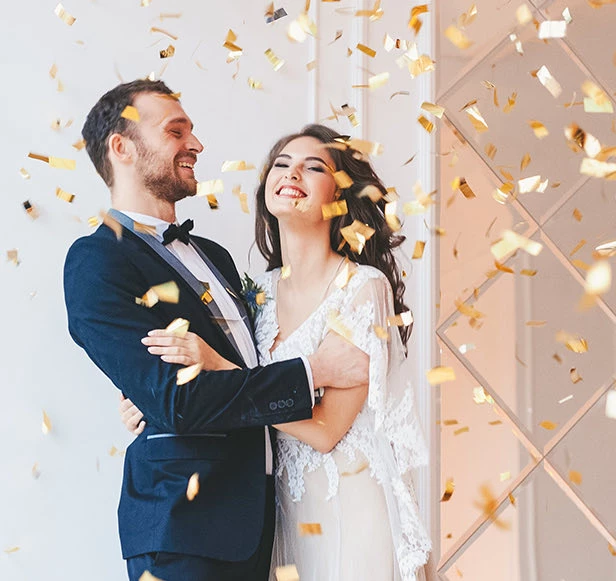 newlyweds enjoying a shower of confetti
