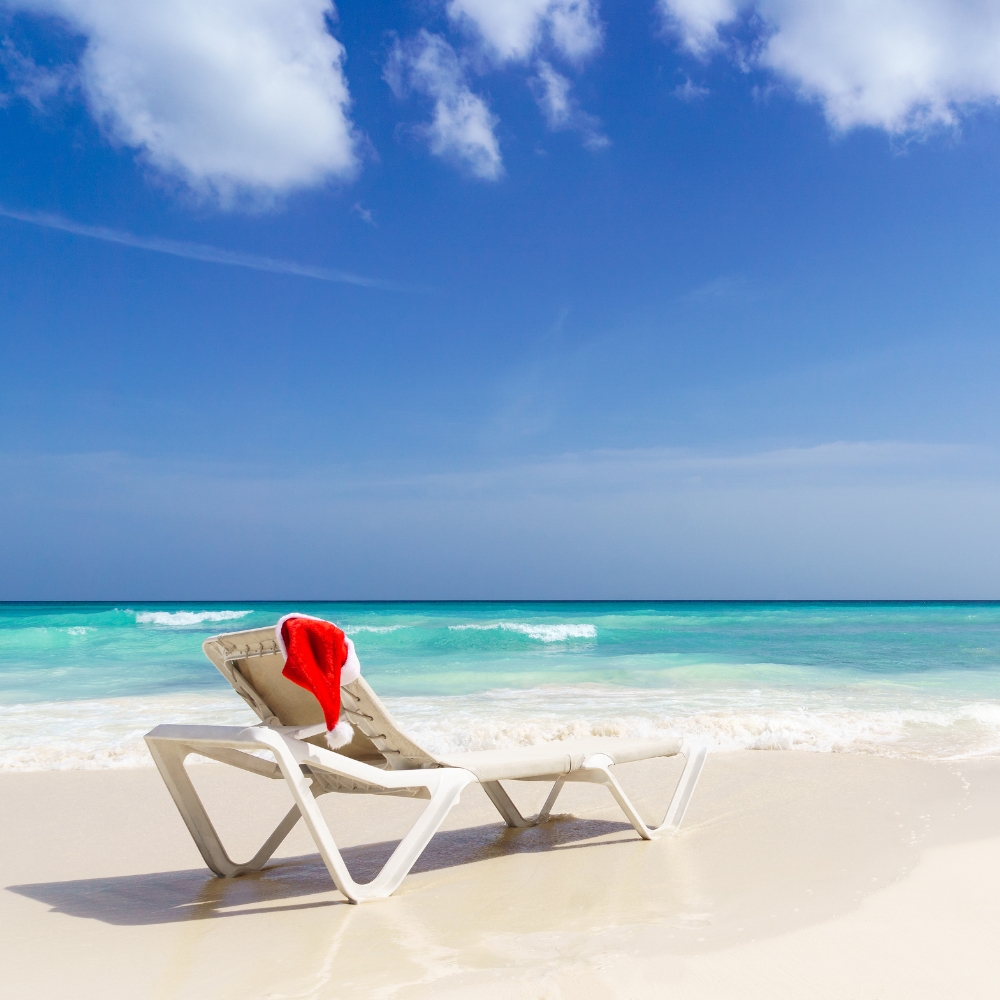 a chair on a beach with a christmas hat