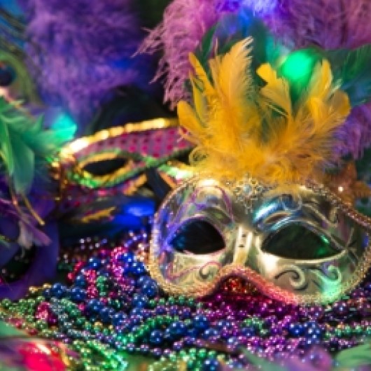 a mask and beads on a pile of beads