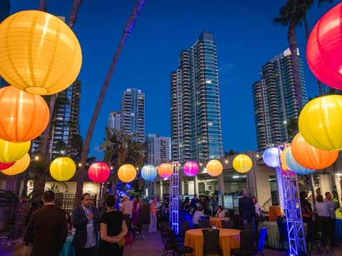 a group of people outside with colorful lanterns