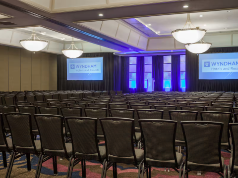 a room with chairs and a projector screen