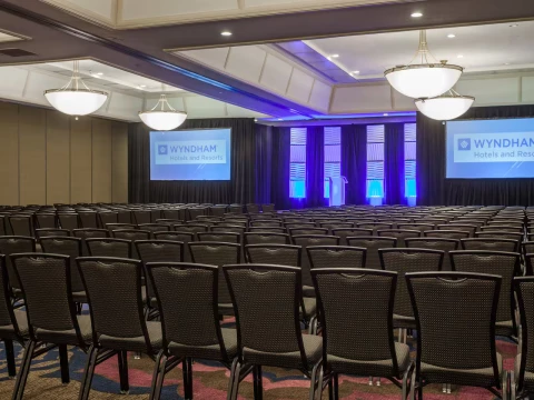 a room with chairs and a projector screen