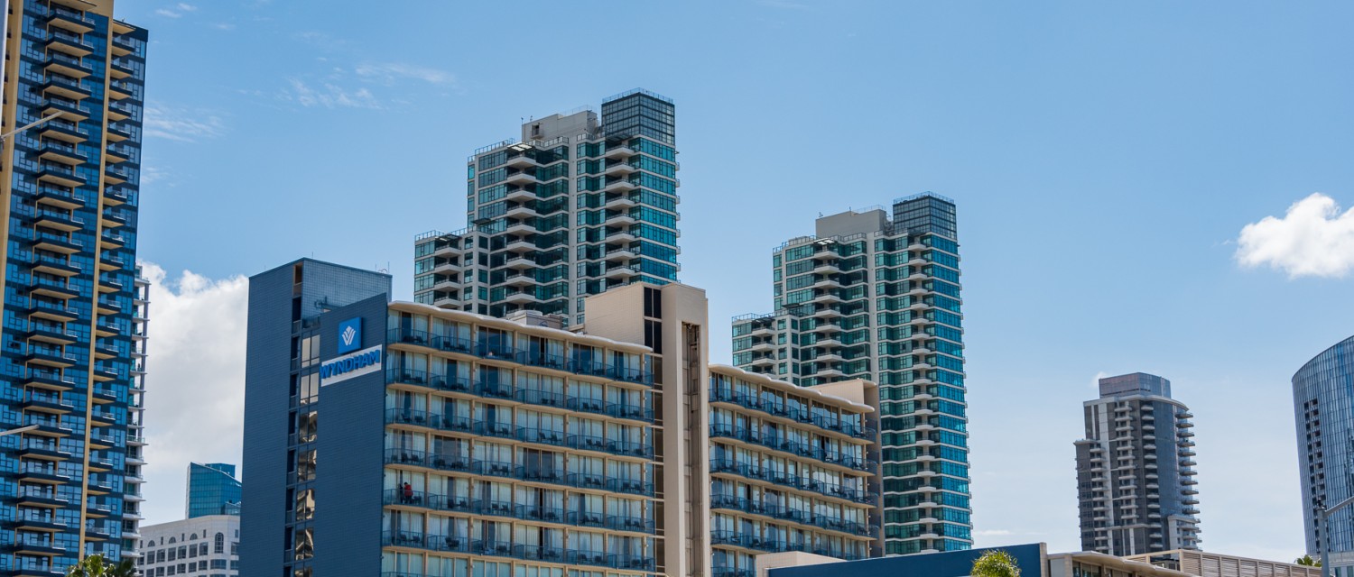 a group of buildings with trees and blue sky