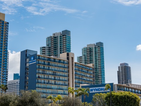 a group of buildings with trees and blue sky