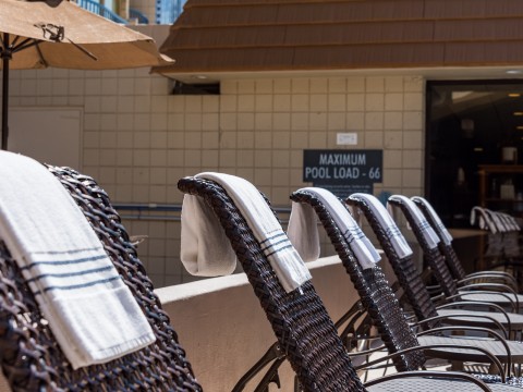 a group of chairs with towels from them
