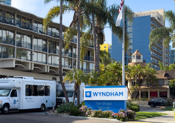 a white bus parked in front of a hotel
